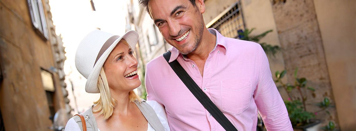 Cheerful couple walking on the streets of Rome